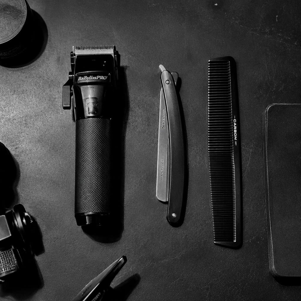 Modern barber tools on a black steel workstation